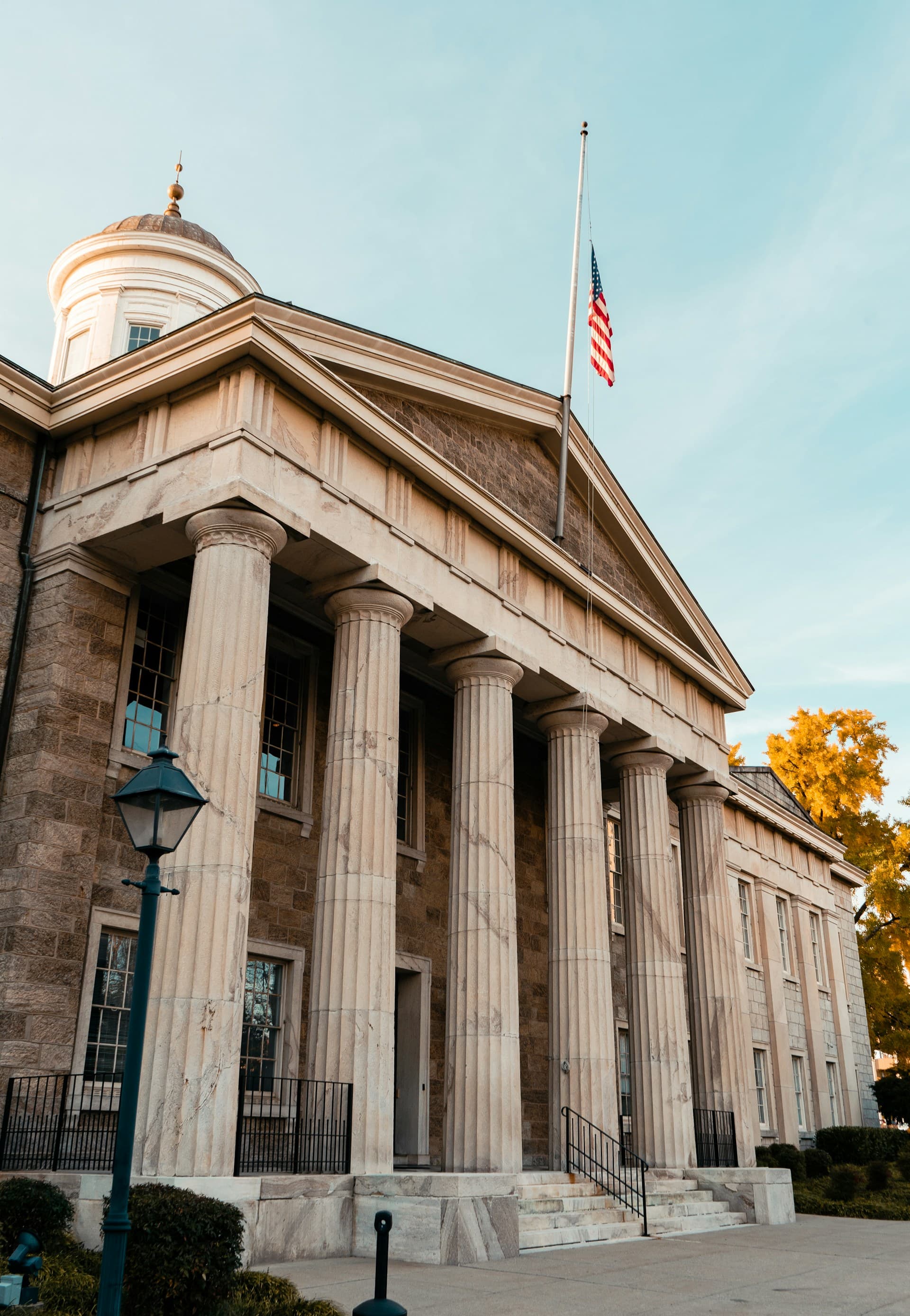 Exterior of a federal courthouse with stone columns at dusk.